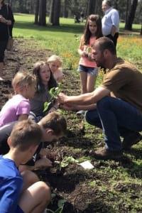 students planting pumpkins